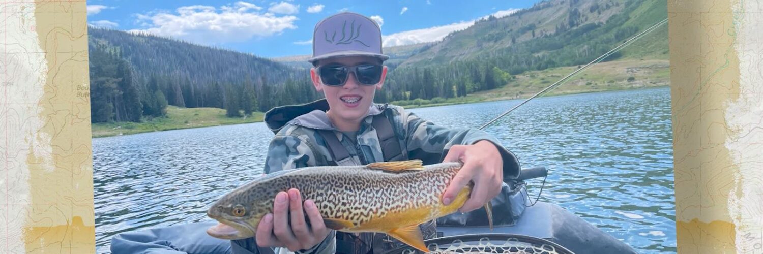Kid holding fish on float tube