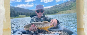 Kid holding fish on float tube