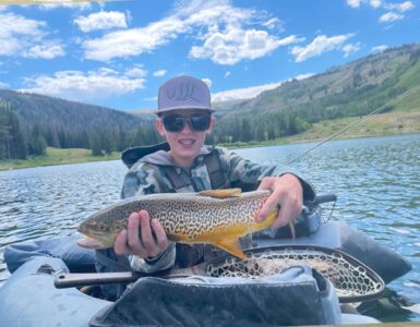Kid holding fish on float tube